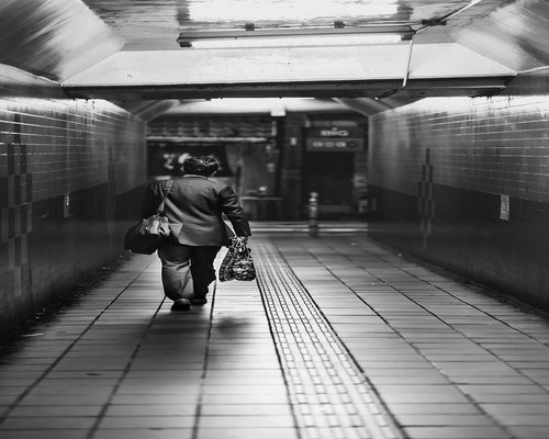 Woman walking smoothly down subway stairs during the morning commute